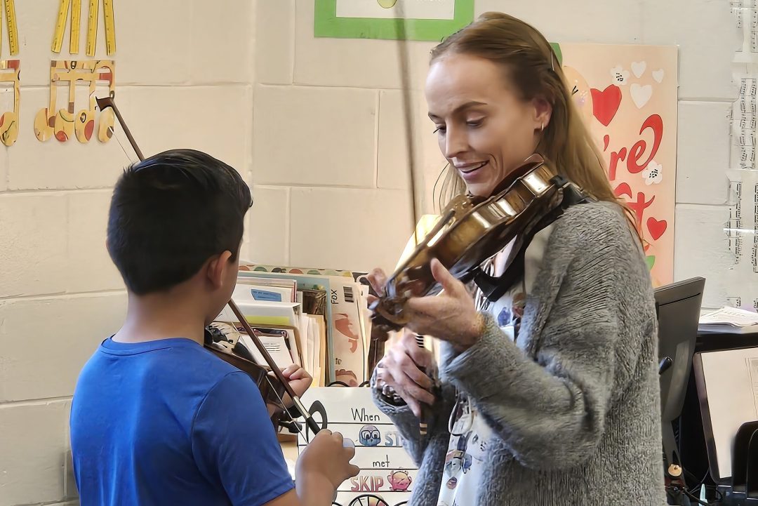 The GIYO String-On! outreach program introduces 5th graders to playing a violin The GIYO String-On! outreach program introduces 5th graders to playing a violin
